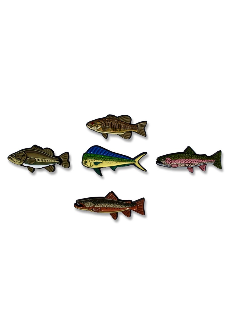 K&ouml;nnte beinhalten: F&uuml;nf Emaillestifte mit verschiedenen Fischarten. Die Stifte sind braun, blau, gr&uuml;n, rot und orange. Die Fische sind ein Barsch, ein Mahi-Mahi, eine Forelle und zwei andere Fischarten.
