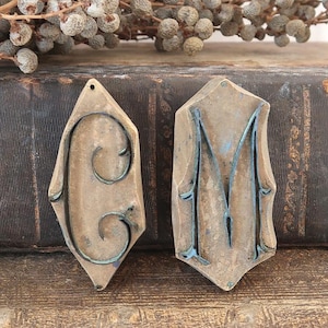 May include: A set of three ceramic mugs with a speckled, matte finish. The mugs are in shades of cream, light gray, and dark gray. Each mug has a simple, minimalist design and a rounded handle. The mugs are likely for coffee or tea.