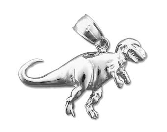 May include: Silver-toned Tyrannosaurus Rex dinosaur charm pendant. The charm is detailed and has a realistic design.