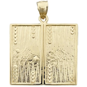 May include: A gold-tone pendant charm shaped like a backgammon board. The charm features a detailed design of the board's squares and triangles, as well as the traditional star in the centre.