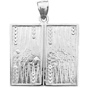 May include: Silver backgammon game pendant necklace. The pendant features a detailed design of a backgammon board with the traditional black and white squares and the points on each side.