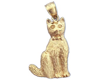 May include: A gold-colored cat charm pendant. The cat is sitting with its tail curled around its legs. The charm has a detailed design and a shiny finish.