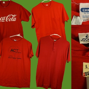 May include: Five red t-shirts with different logos. The logos include Coca-Cola, ACT for Africa, Ched by Anvil, Jockey, and Screen Stars.