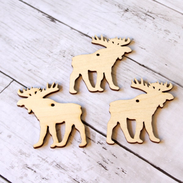 May include: Three unfinished wooden moose ornaments. Each moose is about 4 inches tall and has a hole in the top for hanging.