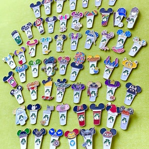 May include: A collection of 40 enamel pins featuring various Disney characters and designs. Each pin depicts a coffee cup with a different character or theme, such as Mickey Mouse, Minnie Mouse, Stitch, and Star Wars.