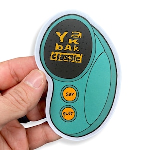 May include: A teal blue sticker with a black circle in the center. The circle has white text that says "Yak Bak Classic" with a yellow outline. The sticker has two buttons, one that says "Say" and one that says "Play".