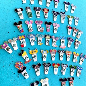 May include: A collection of 40 Disney character themed coffee cup pins. The pins feature various characters such as Mickey Mouse, Minnie Mouse, Donald Duck, Goofy, Pluto, and many more. The pins are all in different colours and designs.