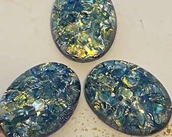 May include: Three oval-shaped iridescent glass cabochons with a blue and green color scheme. The glass has a crackled effect with gold flecks throughout.