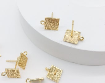 May include: Gold square earring findings with a textured surface and a loop for attaching a charm or pendant.