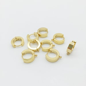 May include: A set of seven gold-toned hoop earrings with a jump ring closure. The hoops are all the same size and have a smooth, polished finish.