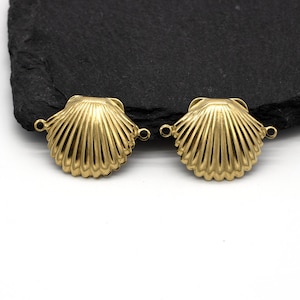May include: Two gold-tone metal seashell charms with a loop on each side. The charms are designed to be used as connectors for jewellery making.