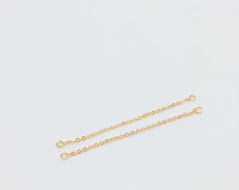 May include: Two gold chain extenders with jump rings at each end.