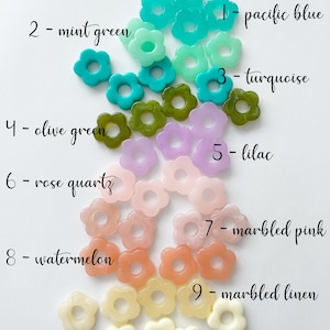 May include: Assortment of 10 flower-shaped resin beads in various colors, including pacific blue, mint green, turquoise, olive green, lilac, rose quartz, marbled pink, watermelon, marbled linen, and ivory.