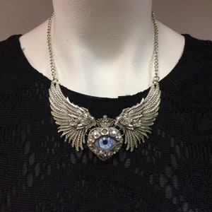 Antiqued Silver Tone Winged Heart Eyeball Art Necklace with a Handmade Blue Glass Iris and Hand Placed Rhinestones!