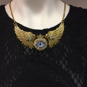 Stunning Antiqued Gold Tone Winged Heart Eyeball Art Necklace with a Handmade Blue Glass Iris and Hand Placed Rhinestones!