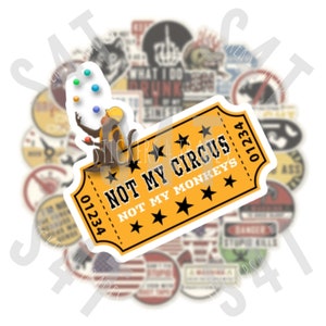 May include: A yellow and white sticker with the text "Not My Circus, Not My Monkeys" and a cartoon monkey juggling balls. The sticker is surrounded by other stickers with various designs.