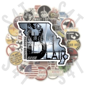 May include: A white sticker with a black outline of the state of Missouri. The sticker features a winter storm scene with power lines and snowflakes. The text "Winter Storm 2025 Blair" is printed on the sticker.