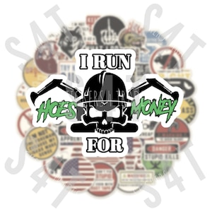 May include: A white sticker with black and green text that reads "I run hoes for money". The sticker features a black skull wearing a hard hat and holding two crossed shovels. The sticker is surrounded by other stickers.