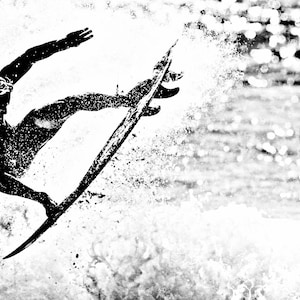 May include: A black and white silhouette of a surfer riding a wave on a surfboard.