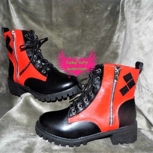 May include: Black and red ankle boots with a zipper on the side and a diamond pattern on the back. The boots have a chunky sole.