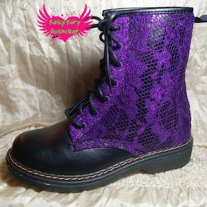 May include: Black leather boots with purple glitter and a snakeskin pattern. The boots have laces and a thick sole.