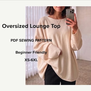 May include: An oversized cream-colored long-sleeve lounge top with a wide neckline. The image includes the text: Oversized Lounge Top, PDF SEWING PATTERN, Beginner Friendly, XS-6XL. The garment features a loose, relaxed fit and simple hem.
