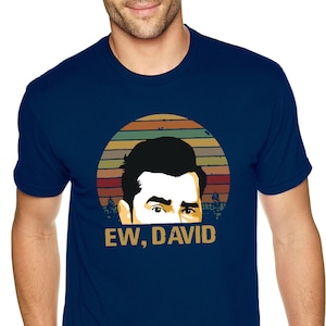May include: A navy blue t-shirt with a vintage-style graphic of a man's face and the text "EW, DAVID".