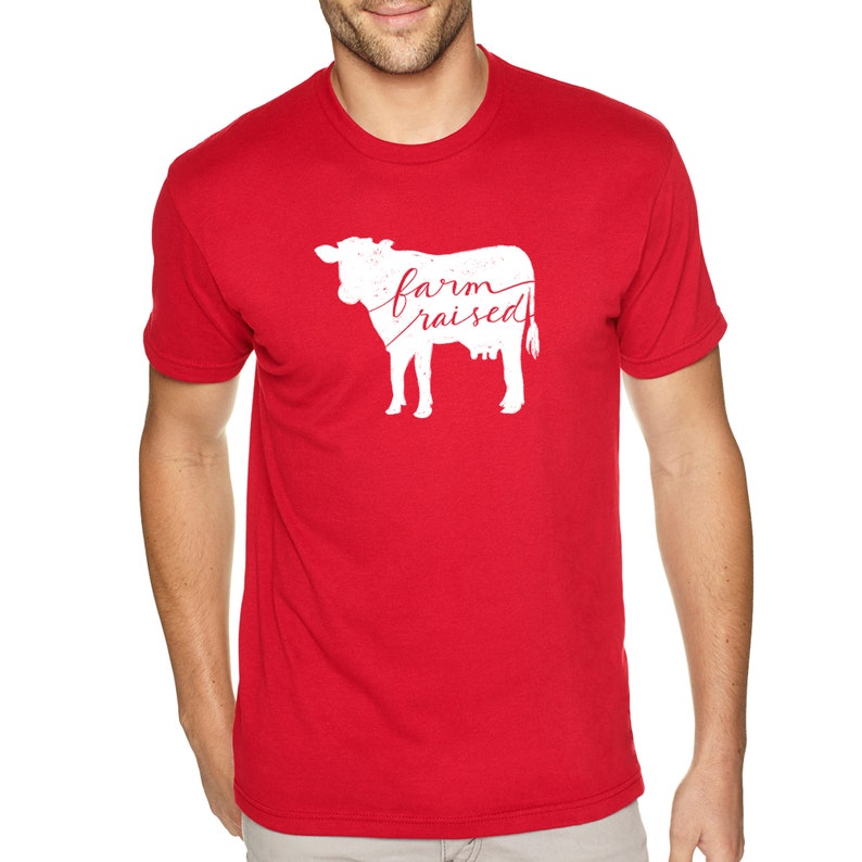 May include: Red t-shirt with a white silhouette of a cow and the text "farm raised" in red.