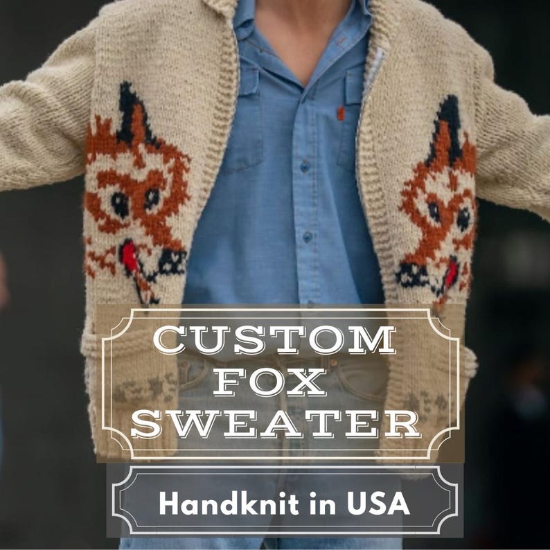 May include: A cream-coloured, hand-knitted sweater featuring a fox design in brown, black, and red. The text "CUSTOM FOX SWEATER" and "Handknit in USA" are displayed on the sweater.