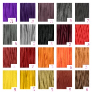 May include: A grid of twenty vertical cord samples labeled 21 through 40, displaying a spectrum of colors including purple, gray, black, red, orange, yellow, and brown. Each section shows the texture of the braided cord material clearly.