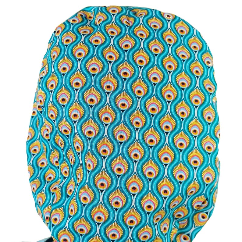 Peacock Scrub CapWoman wearing a peacock scrub cap in Euro style, shown in profile with a bright smile, perfect for women nurses in pediatrics, nephrology, surgery, anesthesia, OBGYN, and medical staff. This doctor scrub hat is available satin lined for hair protection, with optional buttons for masks and personalized embroidery, making it a thoughtful custom doctor gift idea.