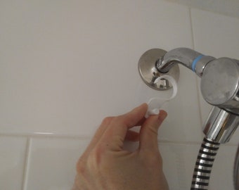 3D Printable ZIP STL file for Home Bath Shower squeege hangers for hanging from show head pipe. Flush, minimal design.