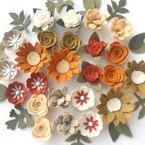May include: Assortment of felt flower embellishments in various colors and styles, including sunflowers, roses, and daisies. The flowers are perfect for adding a touch of handmade charm to crafts, cards, and other projects.