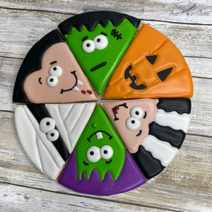 May include: Six Halloween-themed sugar cookies decorated with colorful icing and various characters, including a vampire, Frankenstein, a mummy, and a pumpkin.
