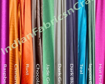 May include: A selection of ten fabric swatches in various colors, including raspberry, cinnamon, rust, chocolate, jade green, dark gray, dark blue, teal, lagoon green, and hot pink.
