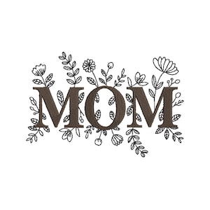 Peut inclure: Motif brodé avec le mot "MOM" en marron, police serif, entouré d'illustrations florales et de feuilles noires et blanches. Le motif est posé sur un fond blanc.