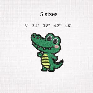 May include: Embroidered green alligator patch with a yellow belly and pink cheeks. The text "5 sizes" is above the alligator, with size options of 3", 3.4", 3.8", 4.2", and 4.6" below.