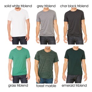 May include: Six different t-shirts in various colors and patterns, including solid white, grey, charcoal black, grass green, forest marble, and emerald green. All shirts are triblend.