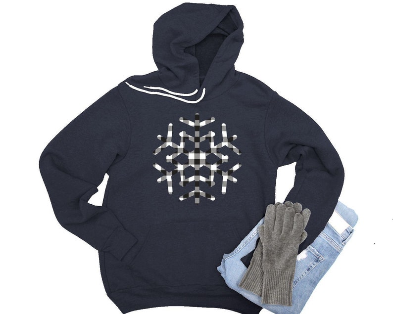 May include: A navy blue hooded sweatshirt with a white and black checkered snowflake design.