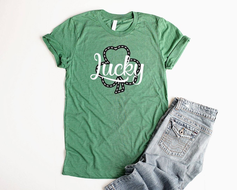 May include: Green t-shirt with a white shamrock design and the word "lucky" in a cursive font.
