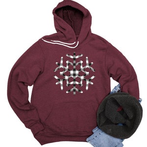 May include: Burgundy hooded sweatshirt with a black and white checkered snowflake design.