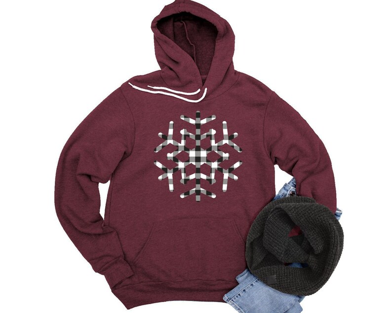 May include: Burgundy hooded sweatshirt with a black and white checkered snowflake design.