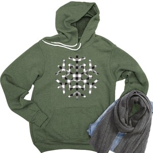 May include: A green hooded sweatshirt with a black and white checkered snowflake design.