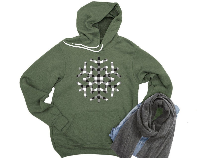 May include: A green hooded sweatshirt with a black and white checkered snowflake design.