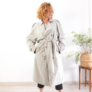 Vintage 90s khaki long trench coat with classic style for women size large or XL. This 1990s casual trench with belt has double breasted button front and pockets.