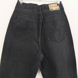 May include: Black denim jeans with a back pocket and a small rectangular label that says "New Horse" in white text.