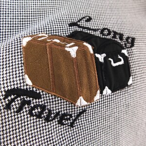 May include: A white and black patterned fabric with embroidered luggage and the text "Long Travel".