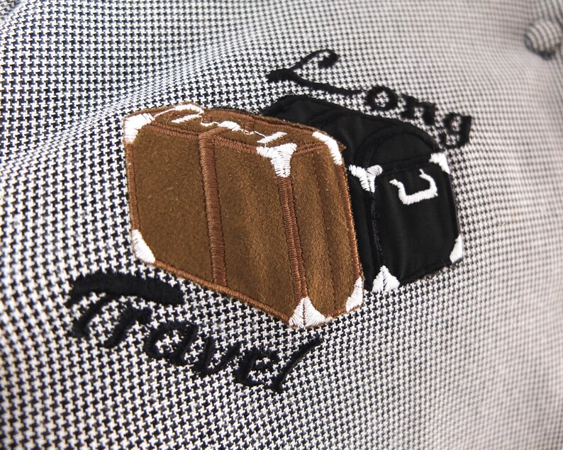 May include: A white and black patterned fabric with embroidered luggage and the text "Long Travel".