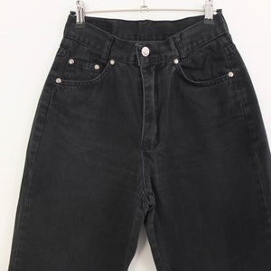 May include: Black denim jeans with a high waist and a straight leg.