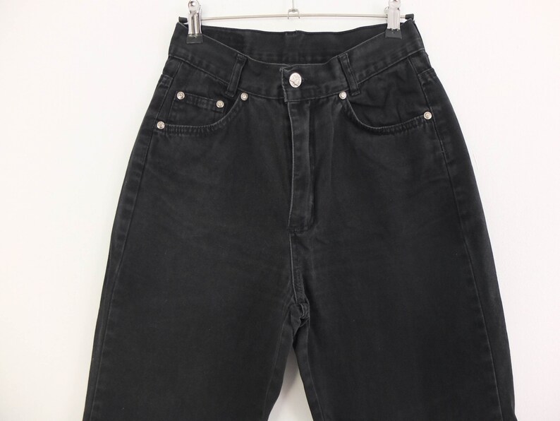 May include: Black denim jeans with a high waist and a straight leg.